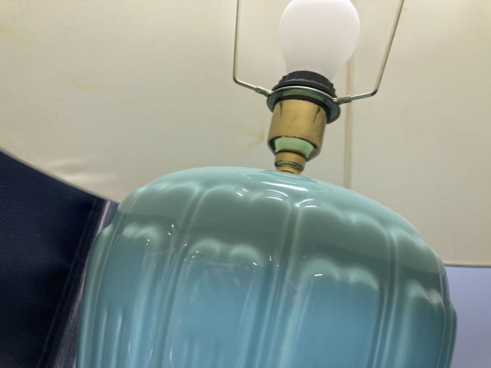 A pair of celadon glazed table lamps, with shades, overall height 63cm